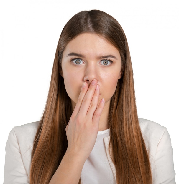 Close-up portrait of surprised beautiful girl holding her head