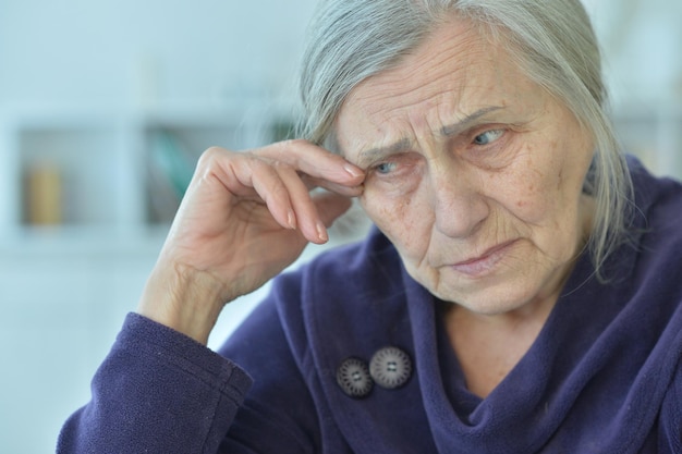 Close up portrait of tired senior woman