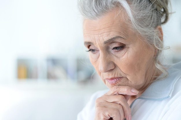 Close up portrait of tired senior woman