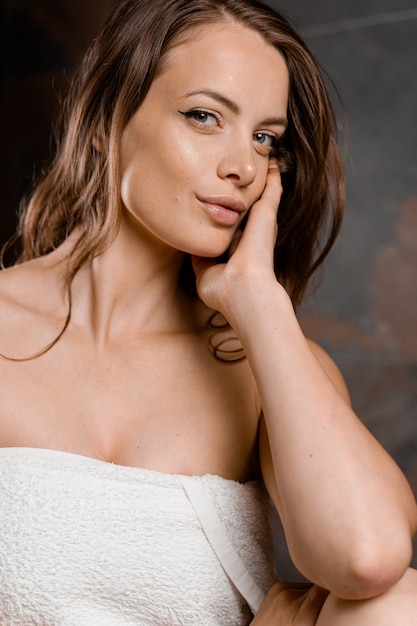 Close up portrait of woman after shower. Girl looks like Angelina Jolie.