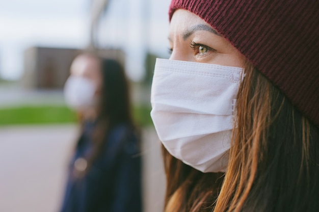 Close-up, portrait of a woman on the background of a girl with a mask.