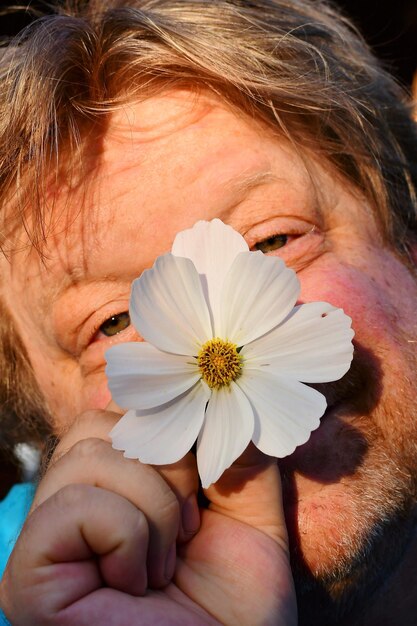 Close-up portrait of woman holding red flower