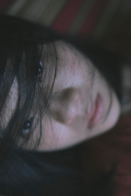 close-up portrait of woman lying on bed