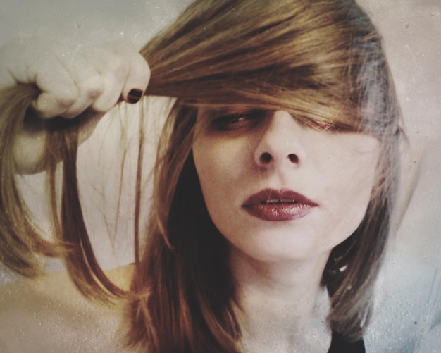 close-up portrait of woman with brown hair at home