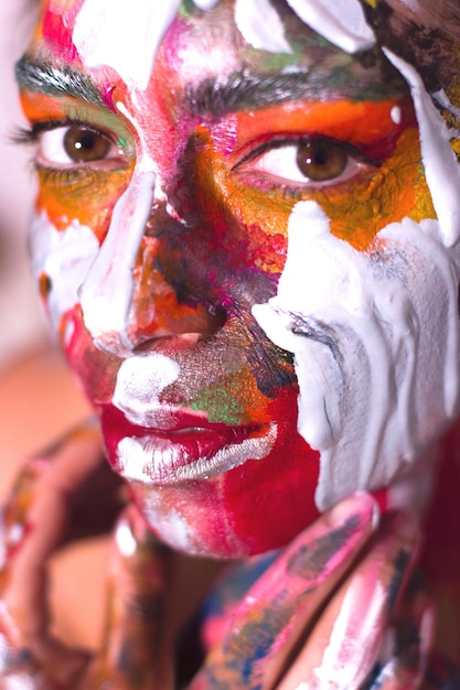 Close-up portrait of woman with colorful face paint