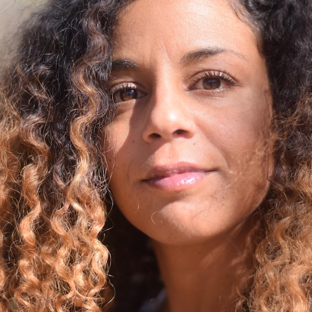 Close-up portrait of woman with curly hair