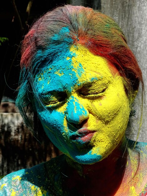 Close-up portrait of woman with powder paint