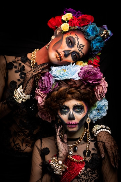 Close up portrait of a woman with a sugar skull makeup dressed with flower crown