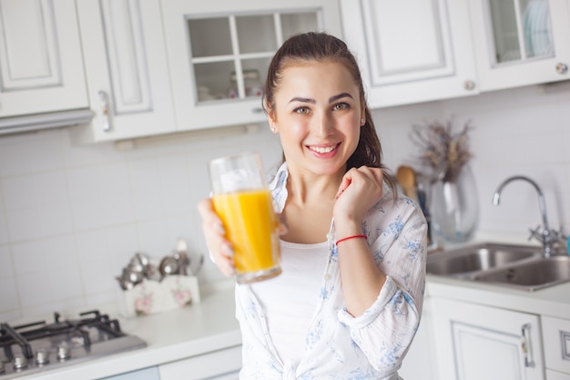 Close up portrait of young attractive woman drinking fresh juice