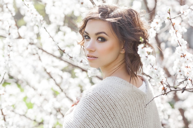 Close up portrait of young beautiful woman on spring  . Attractive young girl with flowers. Spring make up model.