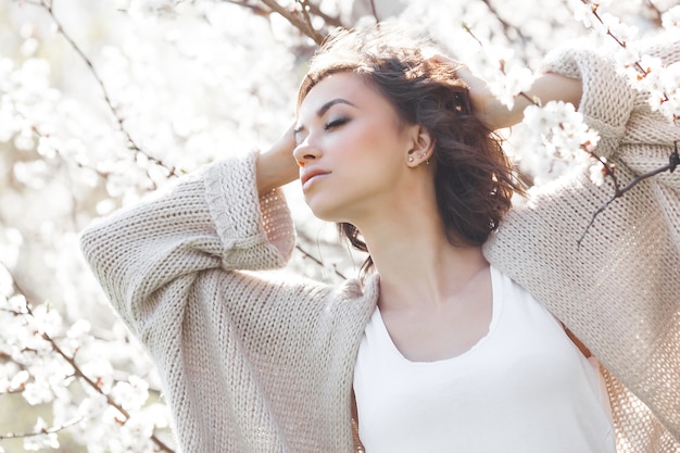 Close up portrait of young beautiful woman on spring  . Attractive young girl with flowers. Spring make up model.