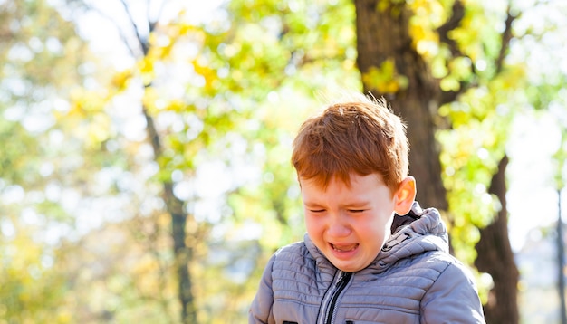 Close up portrait of young boy crying