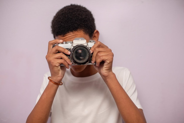 Close up portrait of young boy taking photos