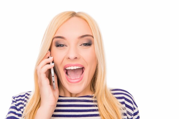 Close up portrait of young excited woman talking on phone