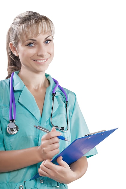 Close up portrait of young female doctor holding clipboard and pen looking at camera smiling isolated