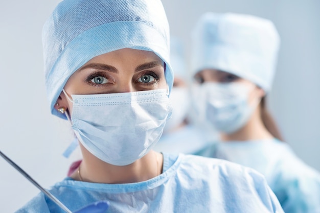 Close-up portrait of young female surgeon doctor at operation theater