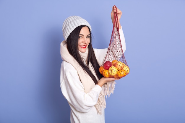 Close up portrait of young girl holding tangerines in her hands