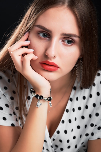 Close-up portrait of a young girl with long hair and red lips.