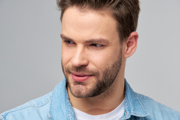 Close-up Portrait of young handsome caucasian man in jeans shirt