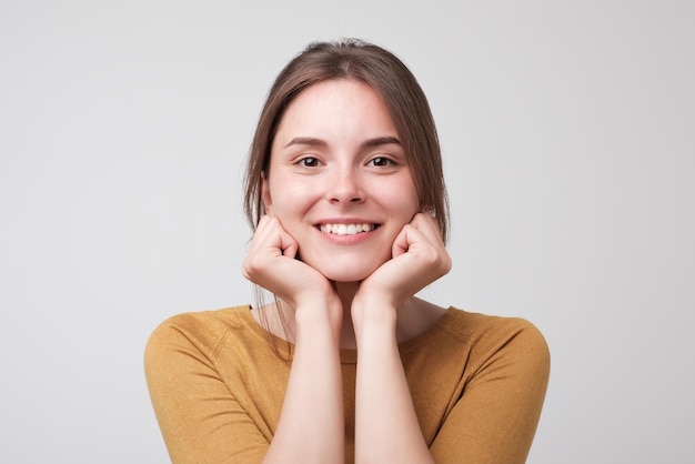 Close up portrait of young happy caucasian woman on white background