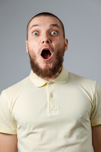 Close-up portrait of a young happy man in a yellow T-shirt