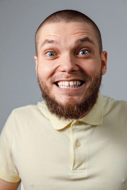 Close-up portrait of a young happy man in a yellow T-shirt