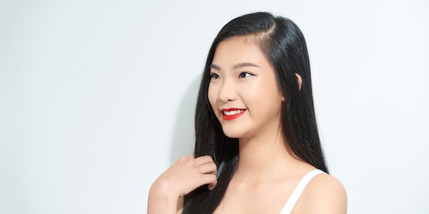 Close up portrait of young happy woman on gray background