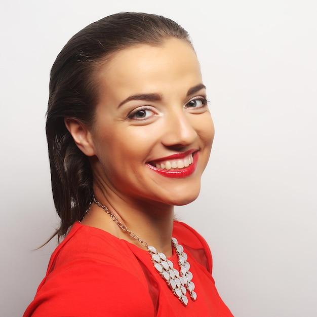 Close up portrait young happy woman in red dress