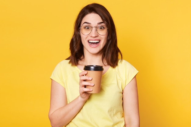 Close up portrait of young lady isolated on yellow studio