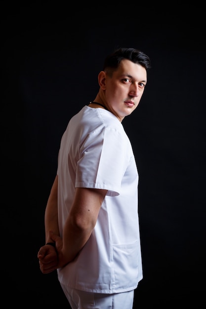 Close-up portrait of a young male doctor in medical clothes.