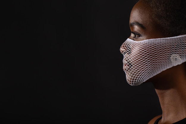 Close-up portrait of young man against black background