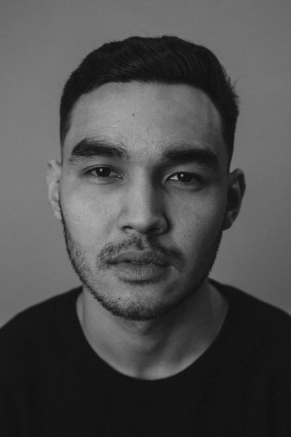 close-up portrait of young man against wall