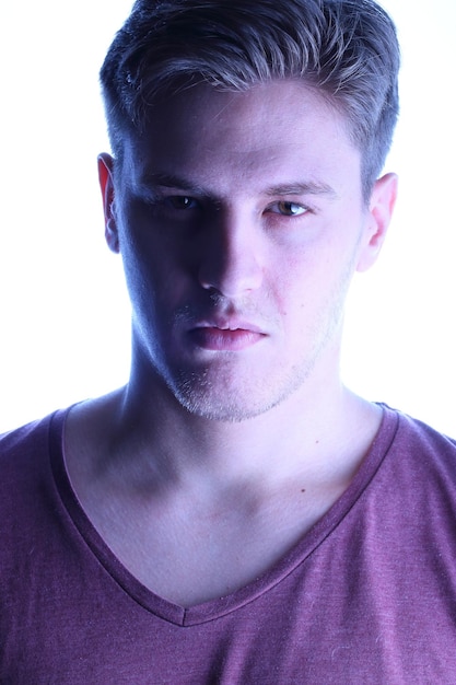 Close-up portrait of young man against white background