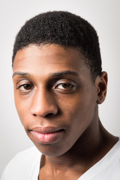 Close-up portrait of young man against white background