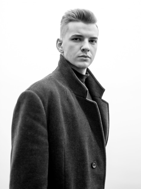 close-up portrait of a young man in a coat