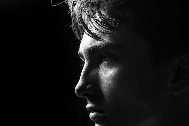 Close up portrait of young man Handsome guy face on black