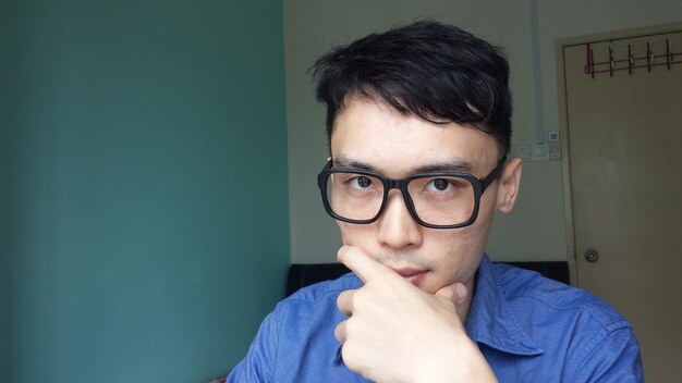 Close-up portrait of young man at home