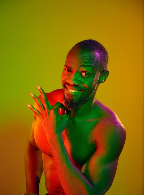 Close up portrait of a young naked happy smiling african man looking at camera