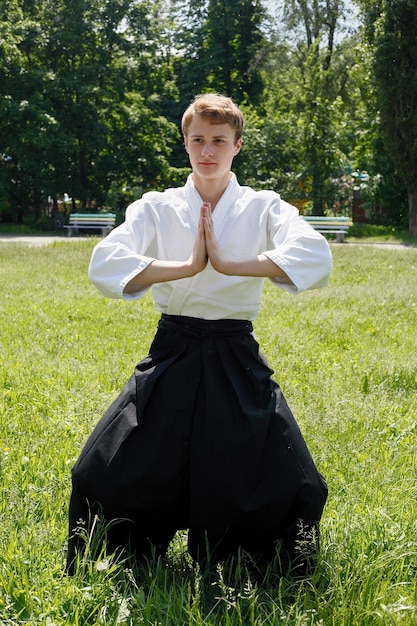 Close up Portrait of young Taekwondo man exercise at the nature park