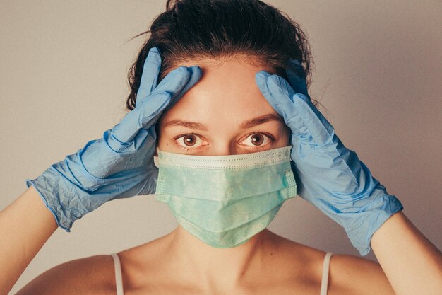 Close-up portrait of a young woman covering face