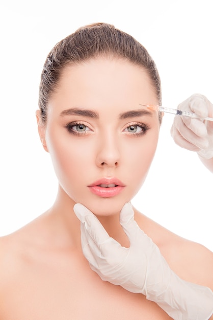 Close up portrait of young woman getting cosmetic injection