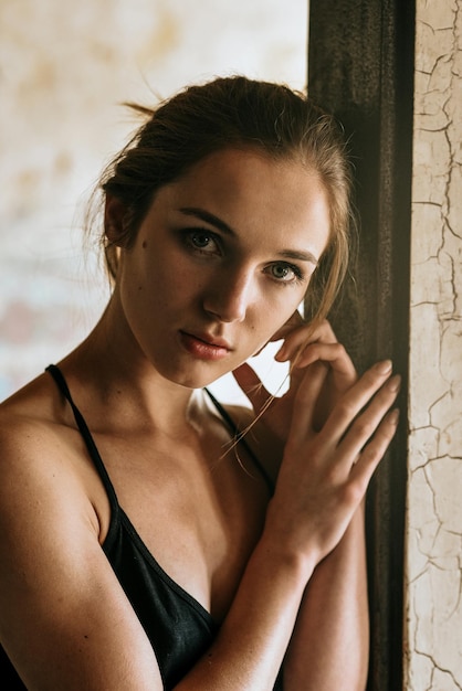 Close-up portrait of young woman at home