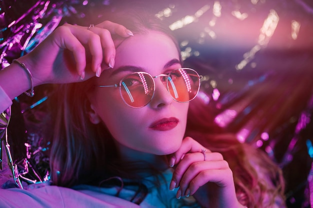 Close-up portrait of young woman wearing sunglasses