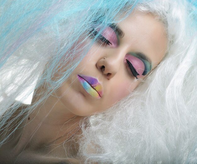 Close up portrait young woman with bright make up and creative hair