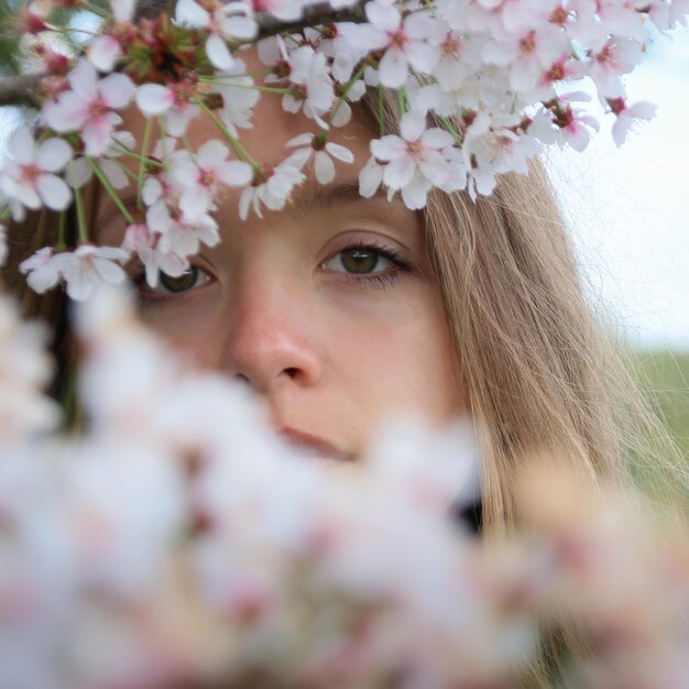 Close-up portrait of young woman with flowers