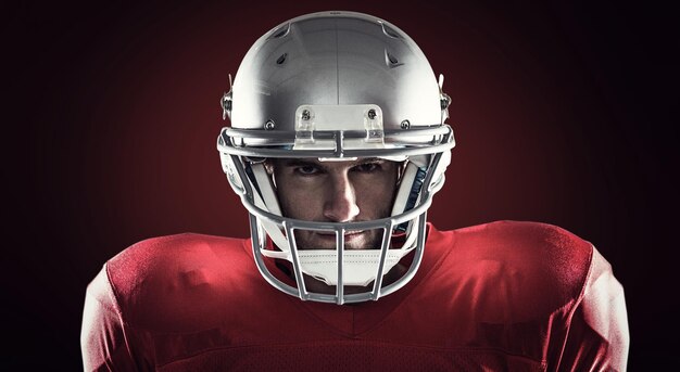 Close-up portret van American football-speler tegen rode achtergrond met vignet