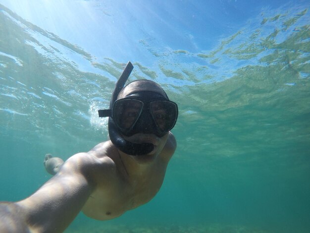 Foto close-up portret van een man die in de zee snorkelt