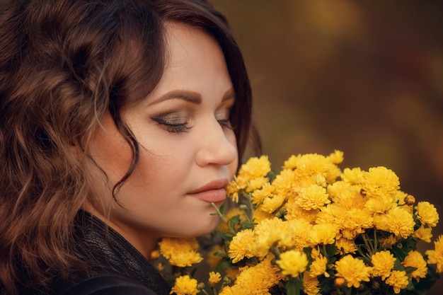 Close-up portret van een meisje met een boeket bloemen in de buurt van haar gezicht