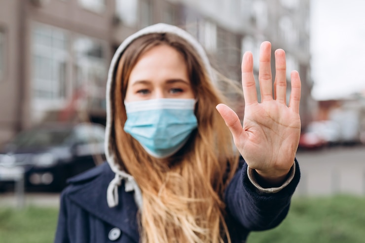 Foto close-up portret van een vrouw in een medisch masker op straat, epidemie van een coronavirus. vrouw schond de regels van zelfisolatie. sars-cov-2. bescherm uzelf tegen covid-19.