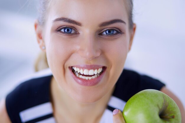 Close-up portret van gezonde lachende vrouw met groene appel.